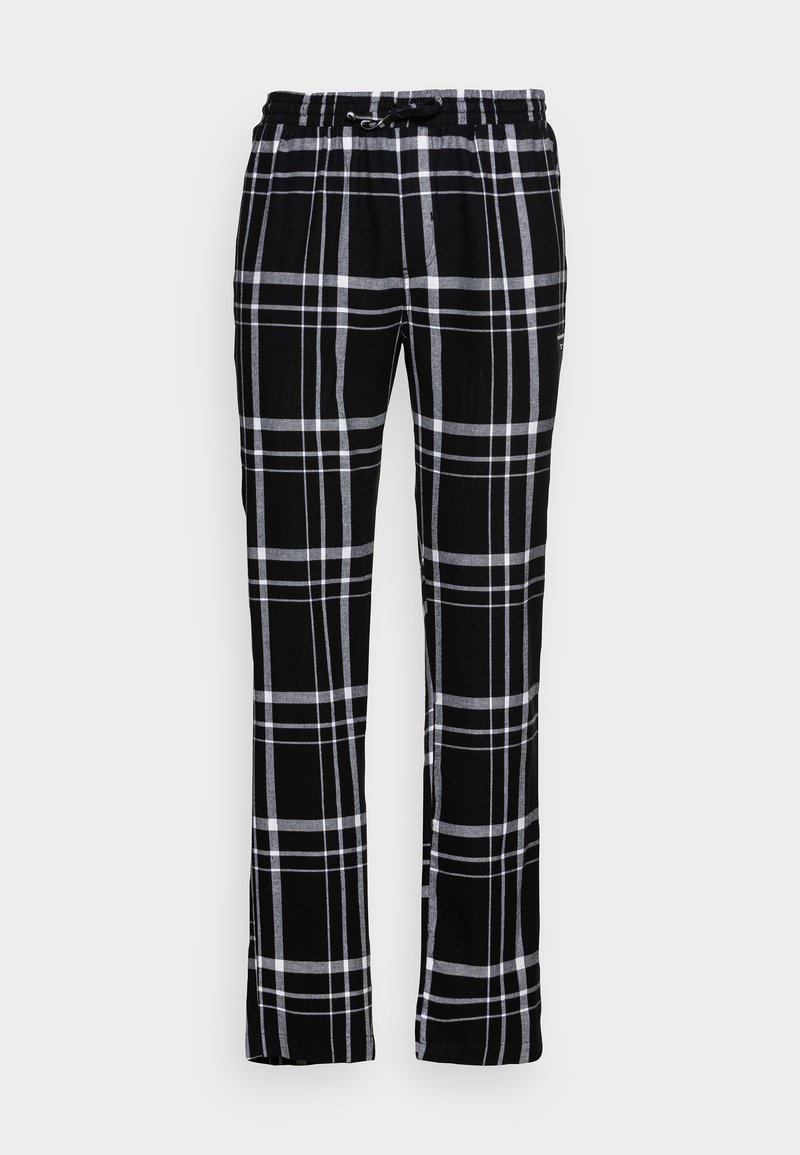 Pantaloni în carouri alb-negru cu croială lejeră, având talie elastică și șnur de ajustare. Materialul pare moale, cu o textură netedă.