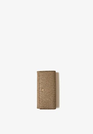 Rectangular beige wallet with small, irregular dark brown spots and a single snap button closure on a white background.