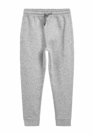 Pantalon de survêtement gris clair avec taille élastique et cordon, poches latérales et poignets côtelés aux chevilles.