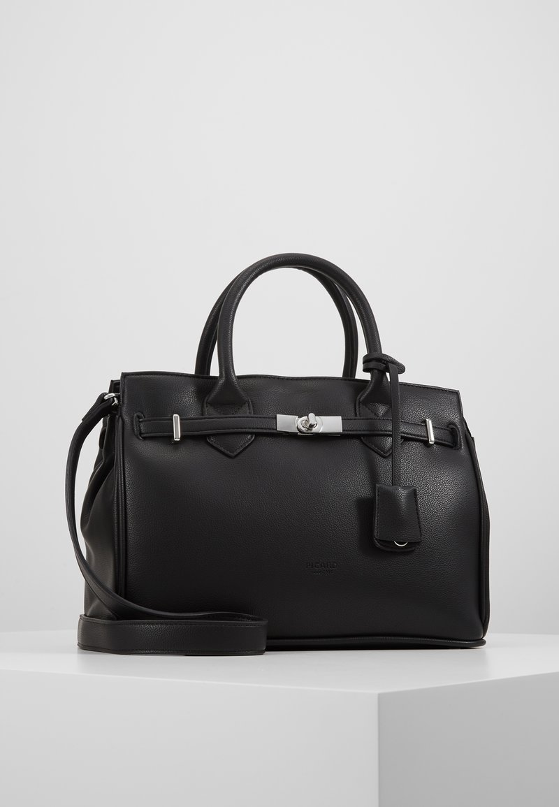 Black leather handbag with dual handles, a detachable shoulder strap, silver hardware, and a hanging tag detail. Smooth texture and structured shape.