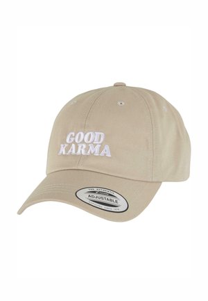 Beige cotton cap with an adjustable strap, featuring white embroidered text “GOOD KARMA” on the front and a smooth, structured bill.
