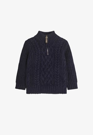 Tums zils adīts džemperis ar augstu apkakli, ar pusi rāvējslēdzēja aizdari un sarežģītiem elementiem visā virsmā. Ribināts apakšmala un aproces.