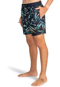 Costume da bagno con sfondo blu navy, decorato con motivi di foglie colorate in teal, giallo e arancione. Vita elasticizzata con cordino e tasche laterali.