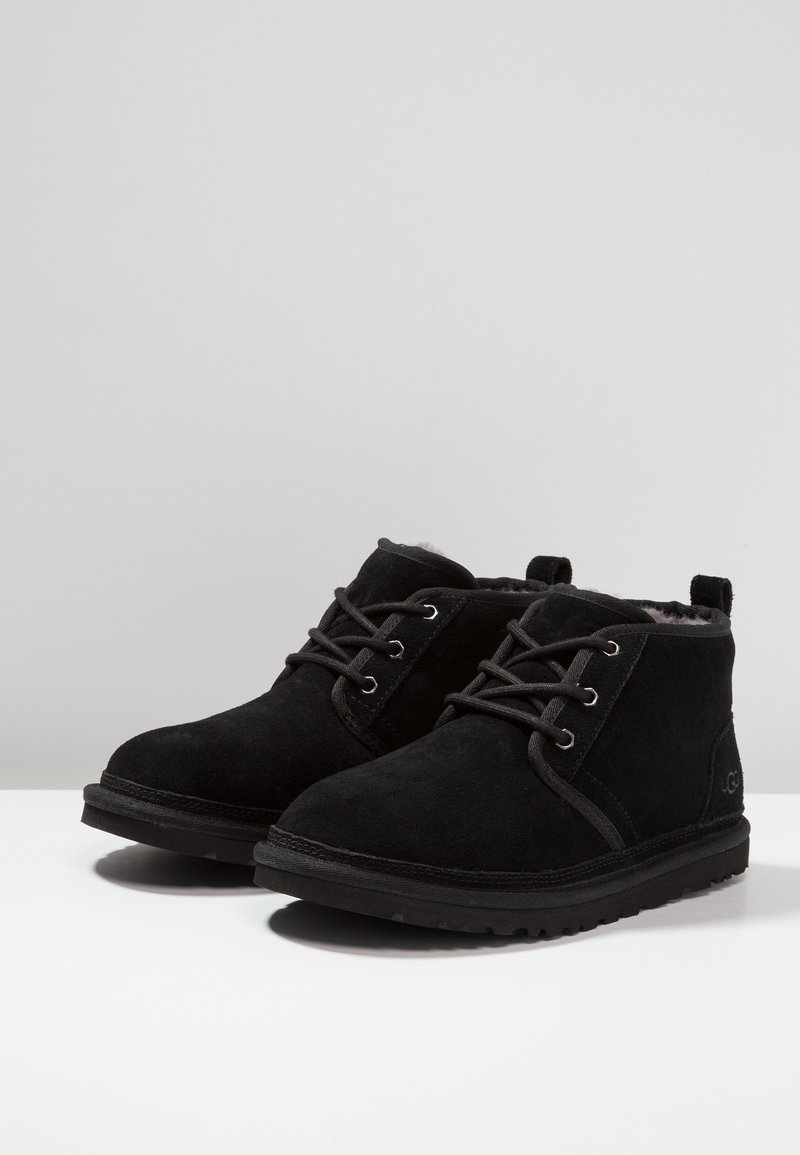 Black suede ankle boots with lace-up front, soft interior lining, and textured rubber sole. Features stitching accents and a rear pull tab.