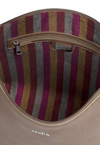 Brown leather bag interior with a zipper pocket; lined with colorful vertical stripes in shades of purple, grey, and brown.