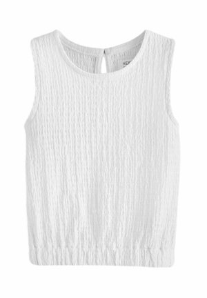Top sans manches blanc en tissu texturé, avec un col rond et un détail en trou de serrure à l'arrière, doté d'un ourlet élastiqué.