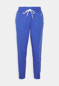 Blå bomullsträningsbyxor med en vit dragsko. Smalare benform med ribbade muddarna och en liten logotyp på övre vänstra sidan.