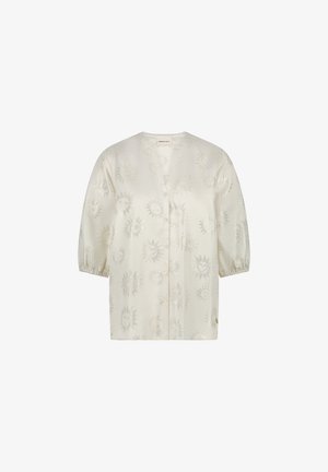 Ecrufarbenes Hemd mit V-Ausschnitt und drei Viertelärmeln, das ein eingeprägtes Muster aus Sonne und Herz zeigt. Knopfverschluss an der Vorderseite.