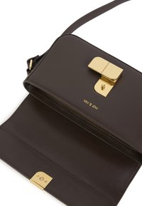 Brown leather crossbody bag with a gold metal clasp and accent. The interior is lined, showing a sleek design and subtle texture.