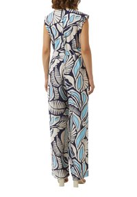 Sukienka na ramiączkach z niebieskim i kremowym wzorem liści. Wykonana z lekkiego materiału, posiada szerokie nogawki i ściągniętą w talii, co podkreśla sylwetkę.