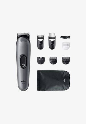 Tondeuse à cheveux Braun AI03 en plastique gris avec un bouton d'alimentation, accompagnée de plusieurs sabots d'attache, une brosse de nettoyage et une pochette noire.