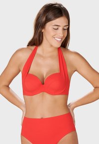 Red bikini set featuring a halter neck design, padded cups, and high-waisted bottom. Smooth texture with a solid color throughout.