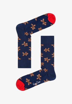 Calzini blu navy con un motivo ripetuto di omini di pan di zenzero, con dettagli rossi sui polsini e sulla punta, realizzati in tessuto morbido. Marchio Happy Socks visibile.