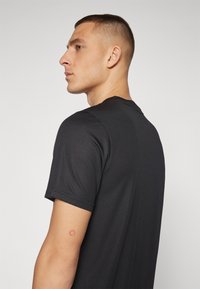 Puma PERFORMANCE TEE - Camiseta deportiva - black
