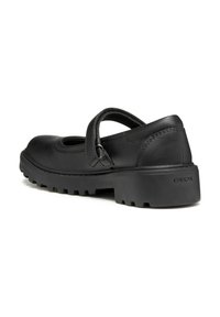 Chaussures Mary Jane noires en cuir avec un bout arrondi, une sangle avec une boucle et une semelle en caoutchouc épaisse et texturée.