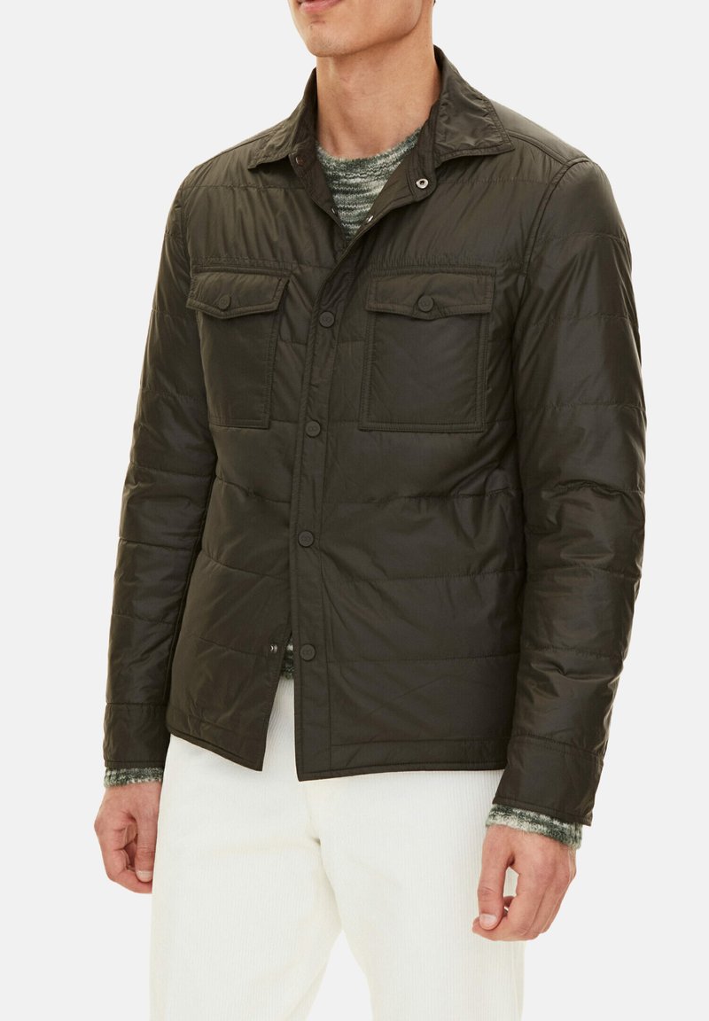 Dark green, quilted jacket with a collared neckline, two chest pockets, lightweight material, and button closure.