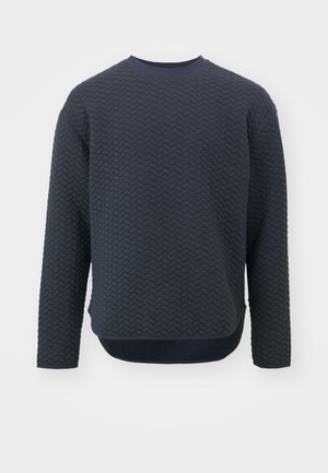 Dark navy crewneck sweatshirt with textured woven design, long sleeves, and a curved hem, featuring a contrasting ribbed collar and cuffs.