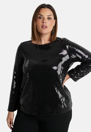 Top lungo con maniche a sbuffo in paillettes nere, con scollatura tonda e vestibilità rilassata, caratterizzato da una texture lucida che riflette la luce.