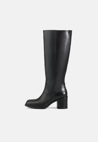 Botas de cuero negro hasta la rodilla con una textura suave, punta redonda y tacón cuadrado. Presentan paneles laterales cosidos y un diseño elegante.