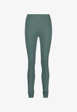 Groene high-waisted leggings van rekbare stof. Heeft een gladde textuur en gathered enkels voor een aansluitende look. Minimale merkdetails.