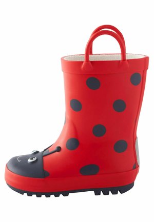Botte de pluie enfant rouge avec des taches noires de coccinelle, bout noir avec yeux et sourire, et deux poignées rouges sur le dessus.