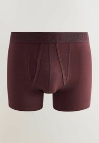 Boxer bordeaux pour homme avec une taille élastique arborant le nom de la marque "NEXT" en relief.