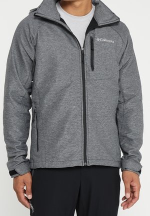 Grijze fleece jack met een rits aan de voorkant, hoge kraag, zijzakken en een borstzak. Voorzien van subtiele gestikte details en een logo.