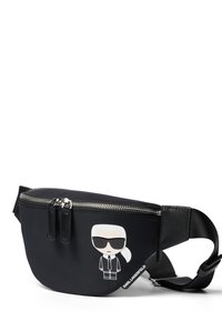 Czarna nylonowa nerka z grafiką kreskówkową przedstawiającą postać w okularach przeciwsłonecznych. Posiada podwójne zamknięcie na suwak i regulowany pasek.