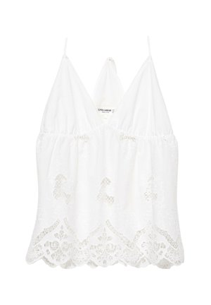 Top court sans manches en dentelle blanche avec ourlet festonné et fines bretelles, orné de broderies florales et d'un décolleté en V.