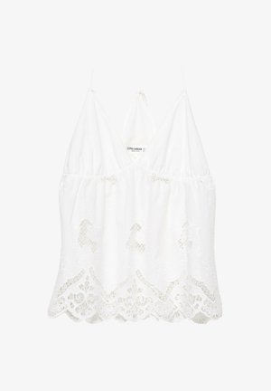 Top court sans manches en dentelle blanche avec ourlet festonné et fines bretelles, orné de broderies florales et d'un décolleté en V.