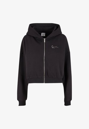 Schwarzer, cropped Hoodie aus weichem Material, mit einem Reißverschluss auf der Vorderseite, gerippten Bündchen und einem kleinen weißen Logo auf der linken Brust.
