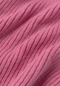 Zart rosa gestrickter Stoff mit dicken vertikalen Rippungen und subtilen Falten, die die Textur und das Webmuster hervorheben.