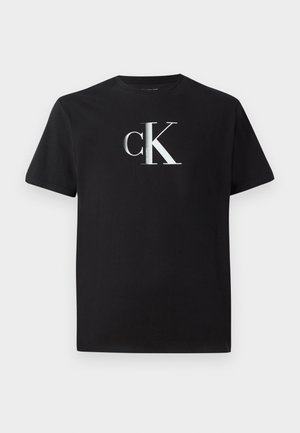 Black cotton t-shirt featuring a silver "ck" logo on the front. Short sleeves and a round neckline with a regular fit.