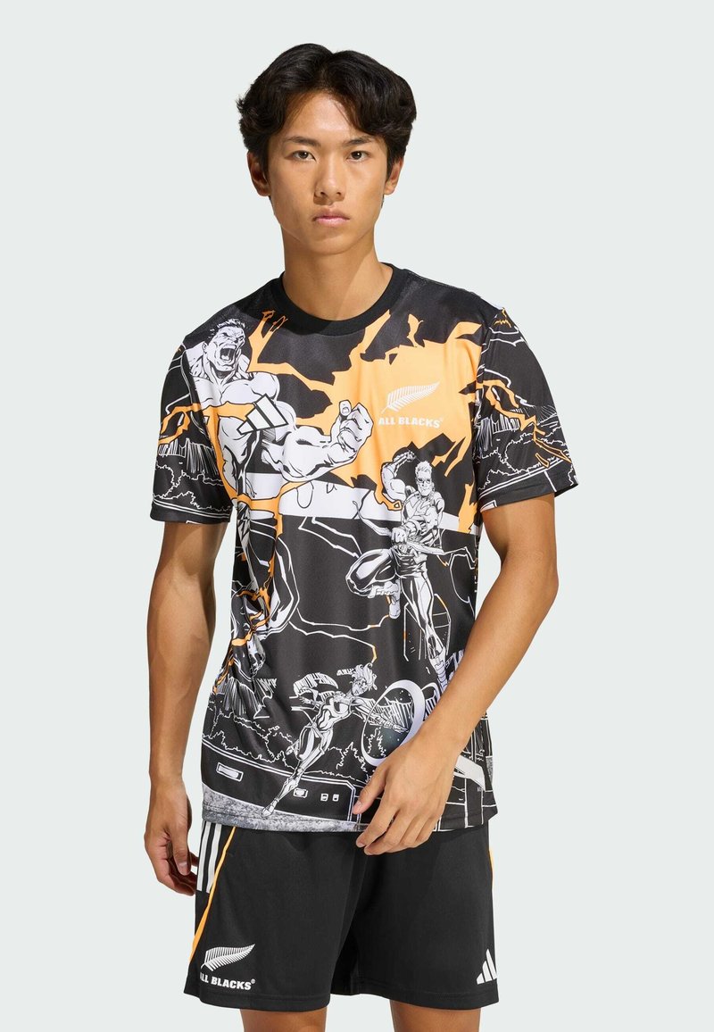 Czarna koszulka z pomarańczowymi akcentami i grafiką w stylu komiksowym. Okrągły dekolt, krótkie rękawy, wykonana z lekkiego materiału. Zawiera logo All Blacks.