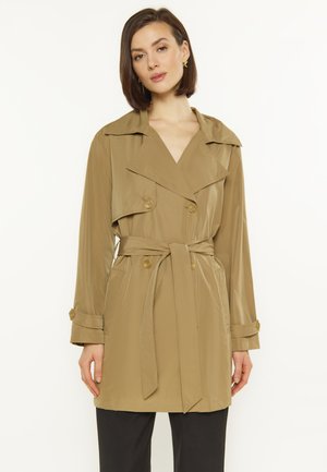 Khaki trench coat with large collar, double-breasted buttons, and a belted waist. Smooth fabric with side pockets and buttoned sleeves.