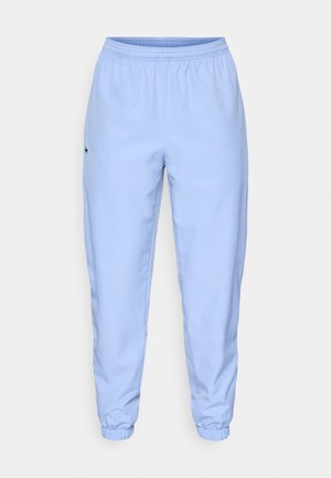 Pantaloni a vita elasticizzata azzurri con polsini arricciati alla caviglia, caratterizzati da un piccolo logo ricamato sul lato sinistro. Tessuto liscio e leggero.