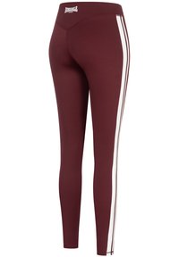 Leggings bordeaux en matériau extensible, avec des rayures blanches sur les côtés et une taille haute avec un détail de logo à l'arrière.