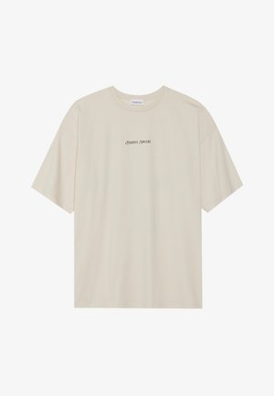 T-shirt de algodão de cor creme com mangas curtas, decote redondo e texto preto a dizer "POSITIVO SINCERO" na frente e nas costas.