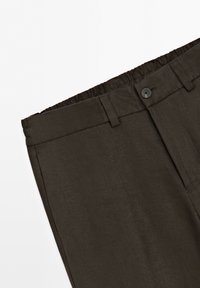 Dark brown pants with elastic waistband, belt loops, a button closure, and a flat front design, shown on a white background.