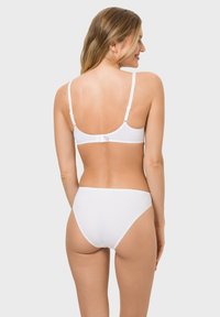 Weißes Lingerie-Set mit einem nahtlosen BH mit verstellbaren Trägern und einem passenden hochgeschnittenen Höschen. Weicher Stoff und minimalistisches Design.