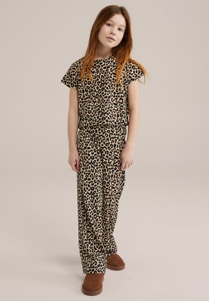 Loungewear set met luipaardprint in tan en zwart, bestaande uit een top met korte mouwen en losse broeken, gecombineerd met bruine slippers.
