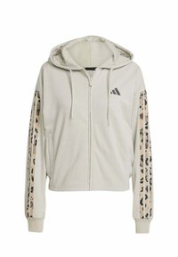 Felpa beige tagliata in tessuto morbido con zip frontale, con strisce a fantasia leopardata sulle maniche e logo Adidas sul petto.