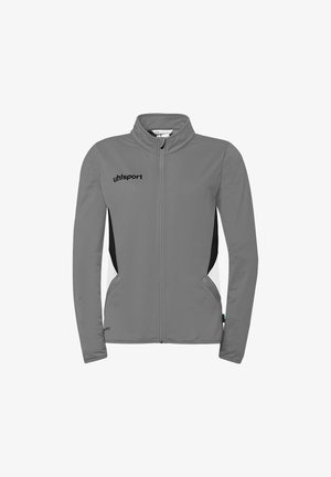 Grijze sportjas met volle ritssluiting, zwarte zijpanelen, hoge kraag, voorzakken en "uhlsport"-logo op de linkerborst.