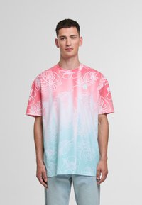 Short-sleeve t-shirt featuring a gradient from pink to light blue, adorned with white floral patterns and a round neckline.