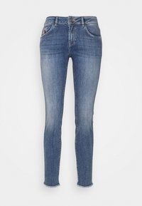 Slim fit jeans i medelblå denim med medelhög midja, femfickorsdesign och fransad fåll vid anklarna.