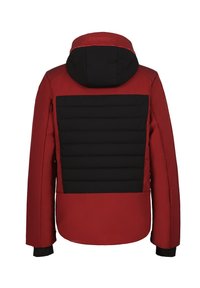 Punainen ja musta huppari-talvitakki, jossa on topattu musta takapaneeli ja pitkät hihat sisäkupeilla.