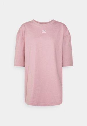 T-shirt oversize Adidas rose clair avec manches courtes et petit logo blanc centré sous l'encolure ronde.
