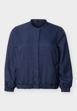 Veste bleu marine à manches longues avec encolure ronde, poignets et ourlet élastiques, fermeture avant cachée et tissu texturé.