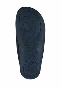Black rubber flip-flop sole with textured grip pattern, featuring a distinctive wave design and rounded edges for comfort.