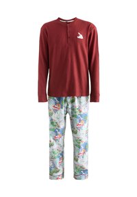 Červený rebrovaný dlhý rukáv s henley výstrihom, v páre s modrými vzorovanými pyžamovými nohavicami s vianočnými motívmi v rôznych farbách.